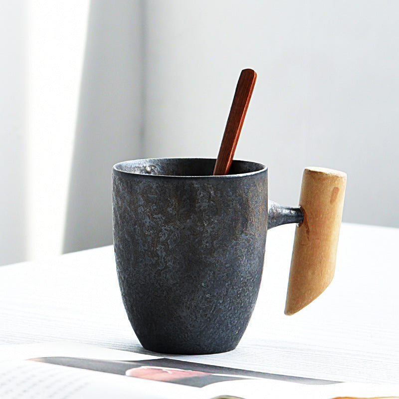Handmade coarse pottery mug with spoon